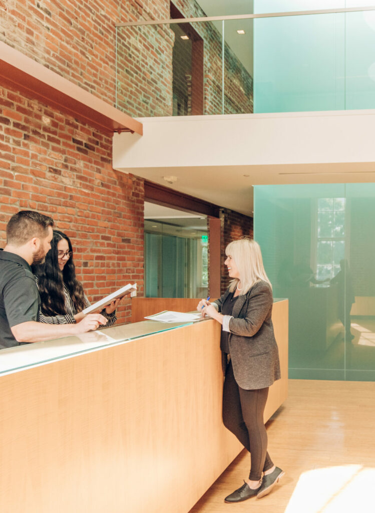 A photo of people standing around a desk at Smith Block building in Portland, Oregon